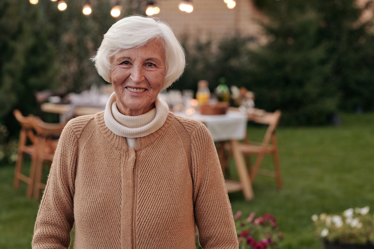 Cheerful senior woman smiling in backyard