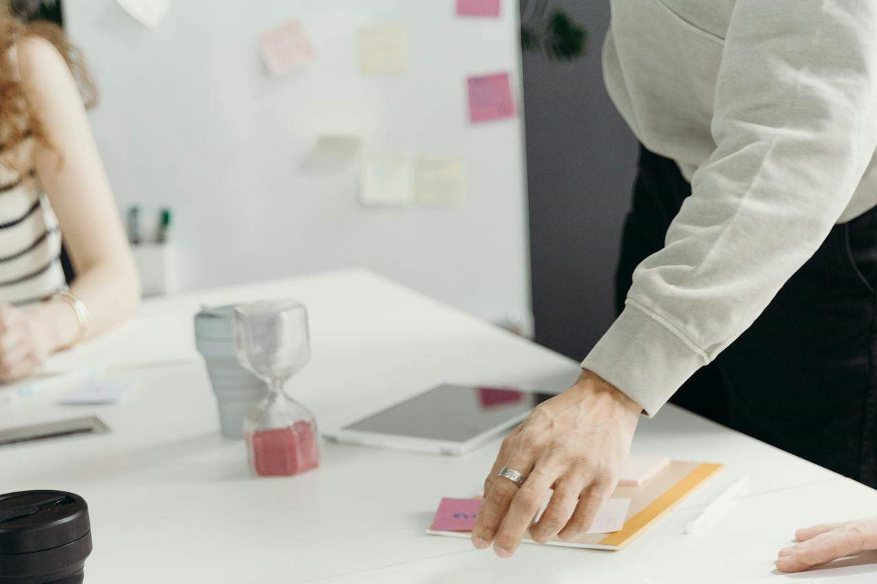 person in white dress shirt holding paper